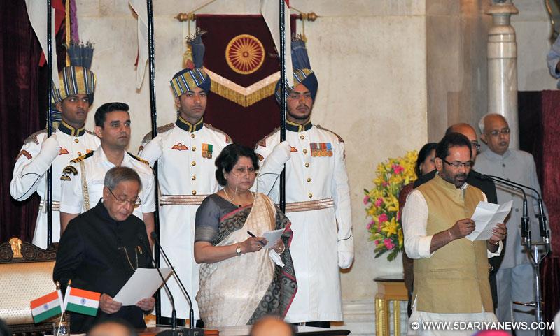 The President, Pranab Mukherjee administering the oath as Minister of State to Mukhtar Abbas Naqvi, at a Swearing-in Ceremony, at Rashtrapati Bhavan, in New Delhi on November 09, 2014. 