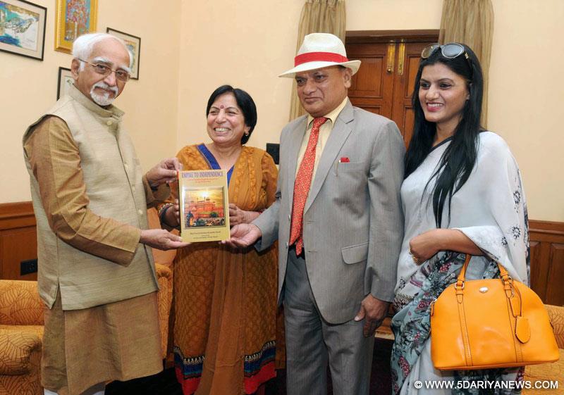 Mohd. Hamid Ansari being presented a book entitled "Empire to Independence", authored by Maj. General (Retd.) Jai Krishan Kaushik, in New Delhi on November 11, 2014. 