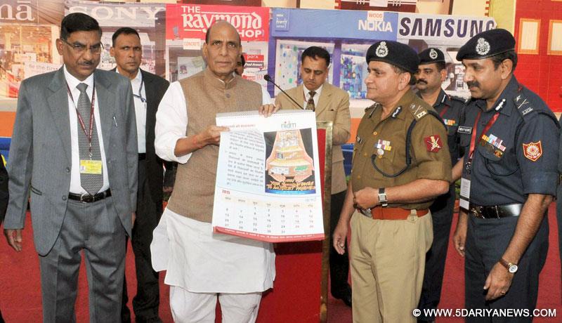 Rajnath Singh releasing a calendar, at the Demonstration of National Disaster Response Force (NDRF), at Pragati Maidan, in New Delhi on November 18, 2014. The Director General, National Disaster Response Force (NDRF),  O.P. Singh is also seen.