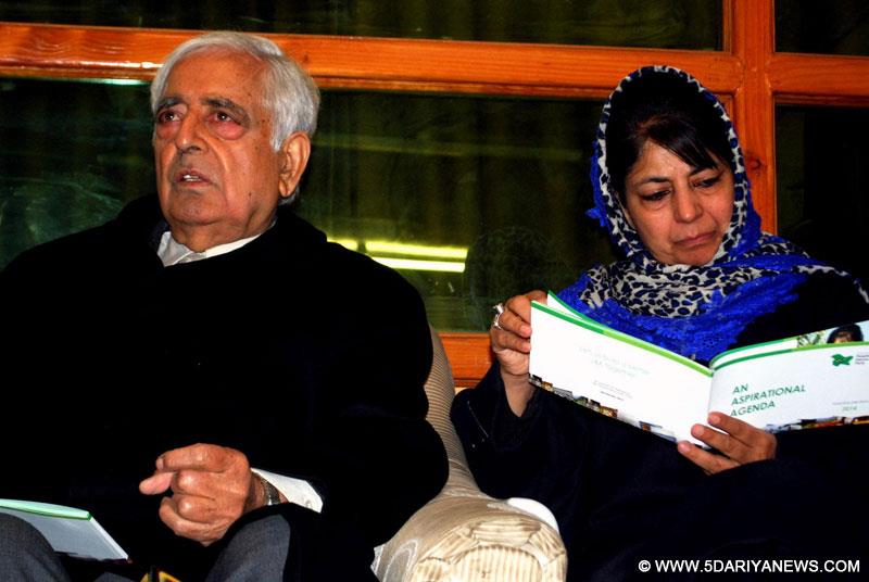 Peoples Democratic Party (PDP) patron Mufti Mohammad Sayeed with party president Mehbooba Mufti at the release of party manifesto ahead of assembly elections in Srinagar on Nov 28, 2014. 