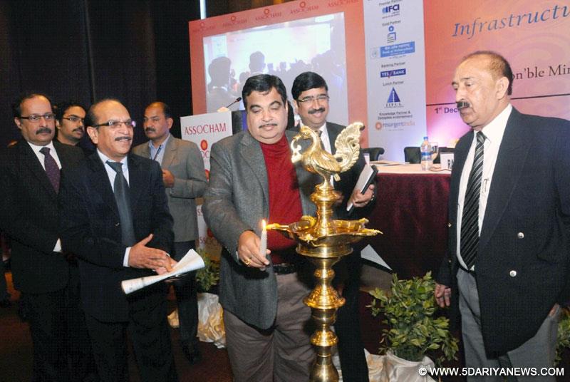 Nitin Gadkari lighting the lamp to inaugurate the International Summit on Infrastructure Finance-Building for Growth, organised by the ASSOCHAM, in New Delhi on December 01, 2014.