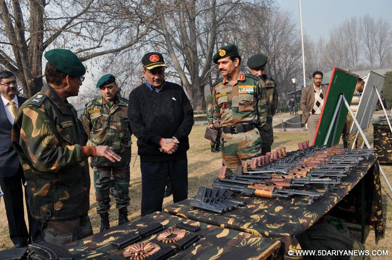 Union Defence Minister Manohar Parrikar inspects the weapons and ammunition seized by the army during its various operations against the militants at the Chinar Corps camp in Jammu and Kashmir on Dec 11, 2014.