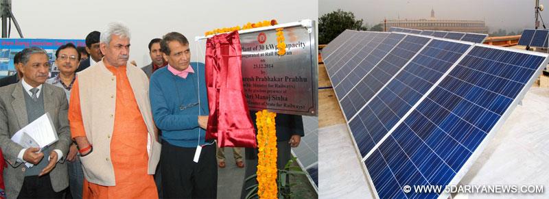 The Union Minister for Railways,  Suresh Prabhakar Prabhu commissioning the 30 kW Solar Plant, at roof top of Rail Bhawan, in New Delhi on December 23, 2014. The Minister of State for Railways, Manoj Sinha and other dignitaries are also seen.