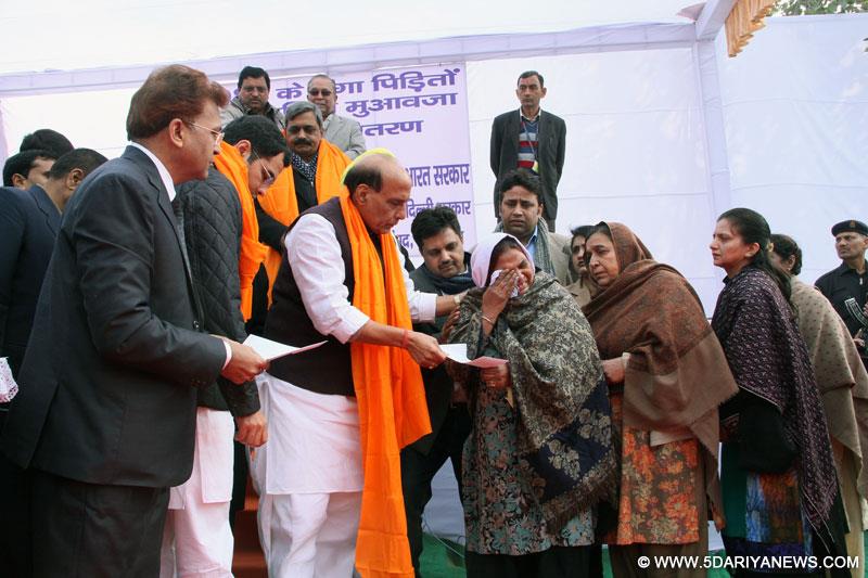 The Union Home Minister, Rajnath Singh presented cheques for hiked compensation to 1984 anti-Sikh riot victims, at a function, in New Delhi on December 26, 2014.