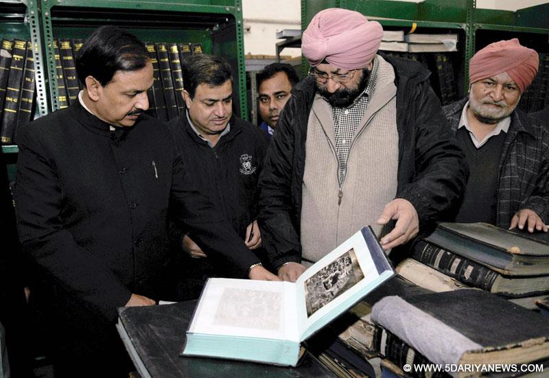 Dr. Mahesh Sharma being shown the old photographs archived with Archeological Survey of India, in New Delhi on January 06, 2015. 