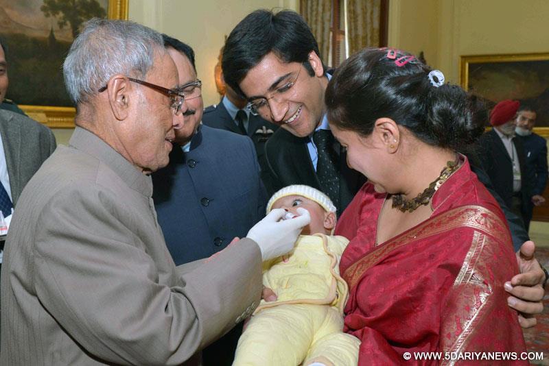 Pranab Mukherjee administering the Polio Drops to a child at the launch of the Pulse Polio Programme, at Rashtrapati Bhavan, in New Delhi on January 17, 2015.