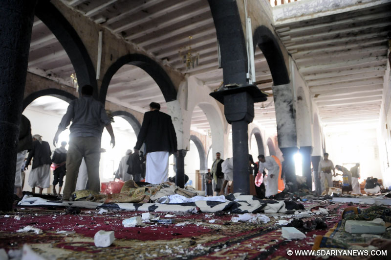 People clear a mosque after a suicide bomb attack in Sanaa, Yemen, March 20, 2015. 