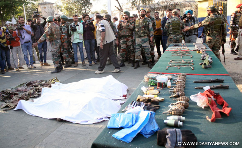 Samba: Soldiers show the arms and ammunition recovered from the militants who launched an attack on an army camp in Samba district of Jammu and Kashmir on March 20, 2015.