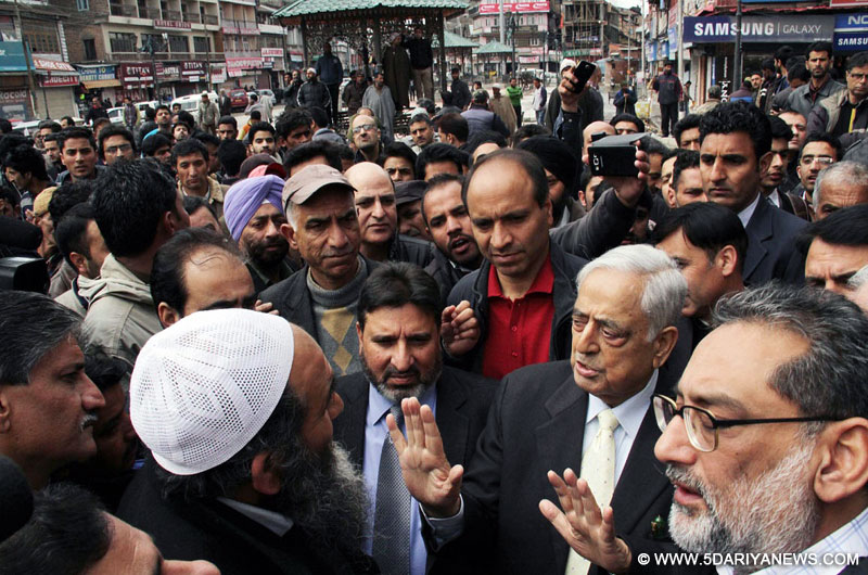 Srinagar: Jammu and Kashmir Chief Minister Mufti Mohammad Sayeed interacts with traders at Lal Chowk of Srinagar regarding floods on March 30, 2015. 