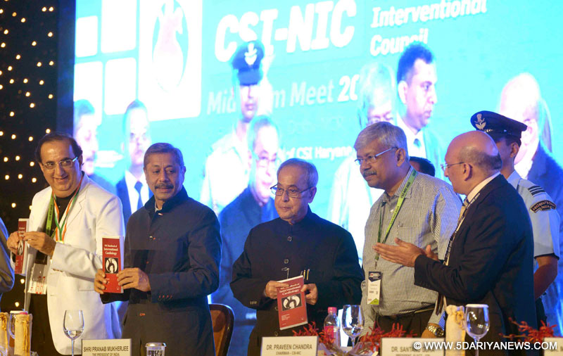Pranab Mukherjee releasing a book at the inauguration of the National Intervention Council (NIC - 2015) meeting of the Cardiological Society of India, in New Delhi on April 04, 2015.