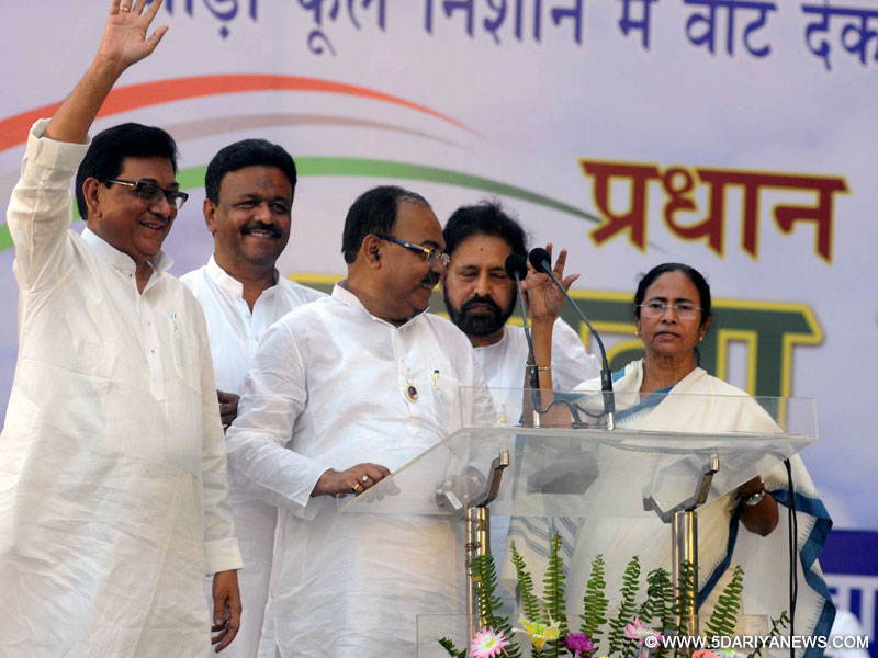 Kolkata: Veteran Congress leader Nirbed Roy joins Trinamool Congress in presence of West Bengal Chief Minister and TMC supremo Mamata Banerjee during a programme in Kolkata on April 10, 2015. Also seen TMC leaders Firhad Hakim and Sudip Bandyopadhyay. 