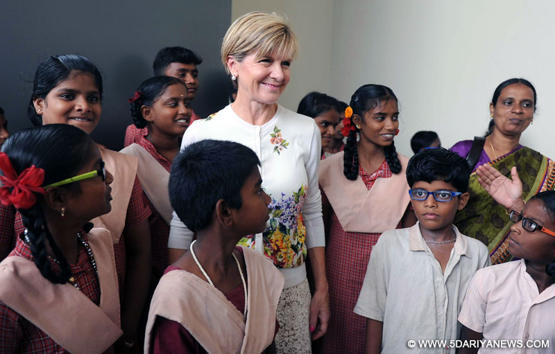 Australian Foreign Minister Julie Bishop interacts with school children at a programme organised to provide free glasses to them as part of an Australian aid program in Chennai on April 15, 2015. 
