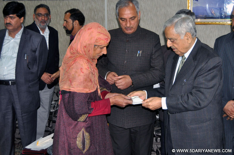 Anantnag: Jammu and Kashmir Chief Minister Mufti Mohammad Sayeed distributes relief cheques to the victims of 2014 floods at Khanabal in Anantnag district of Jammu and Kashmir on April 16, 2015.