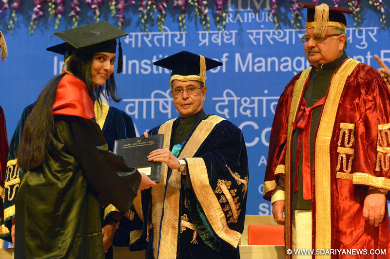 Pranab Mukherjee presenting the degree to a student at the 4th Annual Convocation of Indian Institute of Management (IIM) Raipur, at Raipur, Chhattisgarh on April 17, 2015. The Chief Minister of Chhattisgarh, Dr. Raman Singh is also seen.