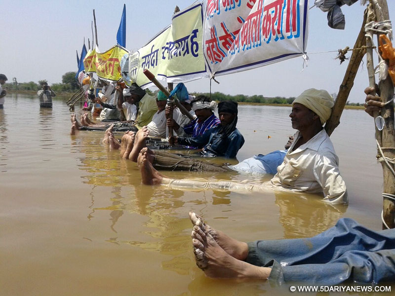 Khandwa: Activists stage a `jal satyagraha` to demand adequate compensation for their submerged land and lowering of water level in the Omkareshwar dam - on Narmada river - in Khandwa of Madhya Pradesh on April 17, 2015. 