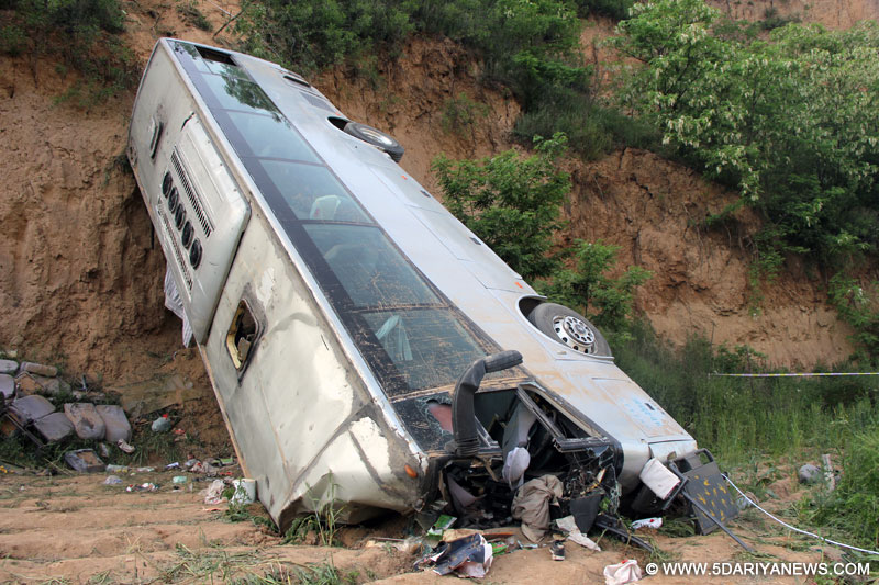 Photo taken on May 15, 2015 shows the accident site after a bus overturned and fell into a valley in Chunhua county of Xianyang City, northwest China