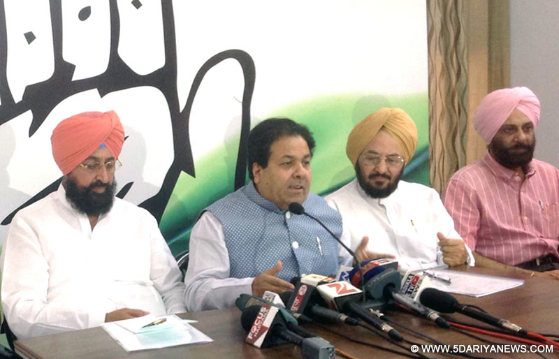 Congress leader Rajiv Shukla addresses a press conference in Chandigarh, on May 22, 2015. Also seen Punjab Congress chief Partap Singh Bajwa. 