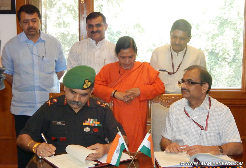 The Mission Director, NMCG, T.V.S.N. Prasad and the Director General, NYK, Major General Dilavar Singh signing an MoU for Clean Ganga Mission between National Mission for Clean Ganga and Nehru Yuva Kendra, in the presence of Uma Bharti, in New Delhi on June 08, 2015.