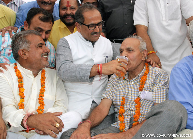 Jammu and Kashmir Deputy Chief Minister Nirmal Singh offer juice to members of AIIMS coordination committee after ending their seven days long hunger strike in Jammu on June 18, 2015.
