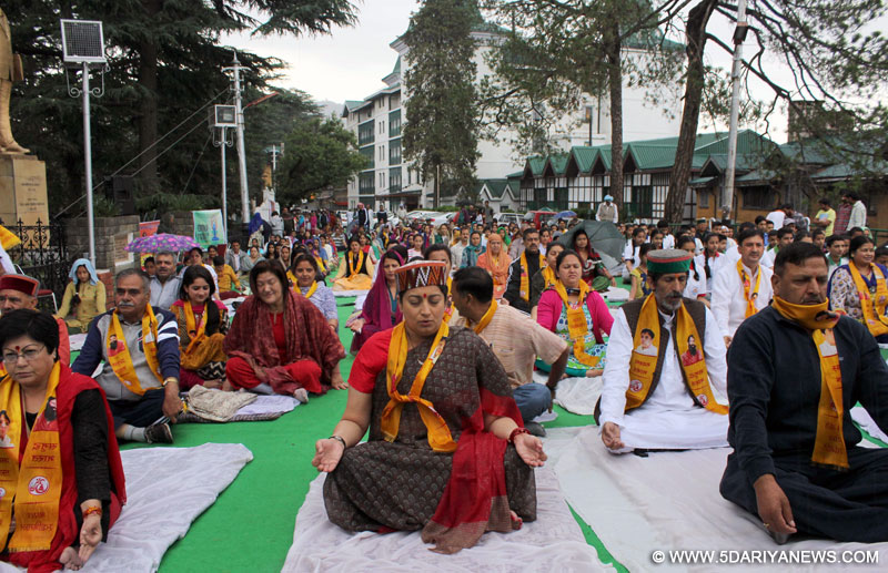 Union HRD Minister Smriti Irani participates in a yoga session along with people on the occasion of International Yoga Day at Chaura Maidan in Shimla on June 21, 2015. 