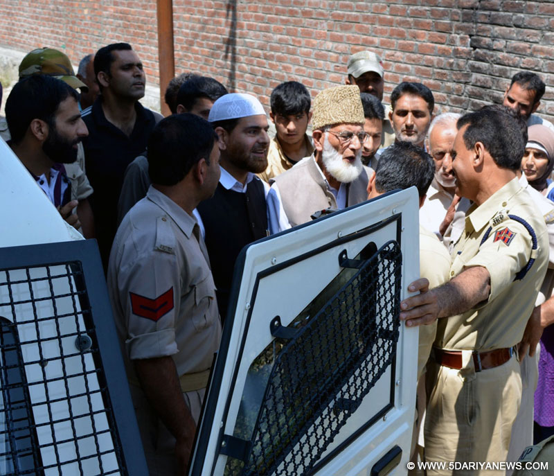 Srinagar: Hurriyat chief Syed Ali Shah Geelani being taken away by police from his Hyderpora residence after he left home to address a rally in Srinagar on July 3, 2015