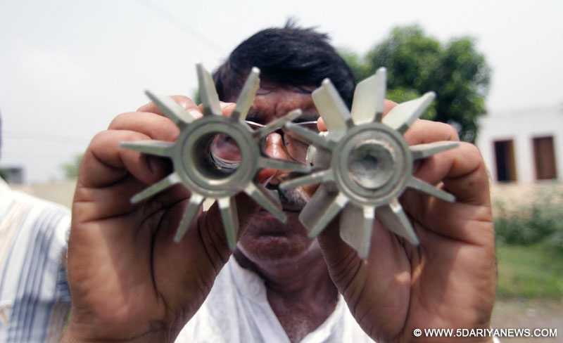 Malana: A villager show a portion of a mortar allegedly fired from Pakistan at Malana village in R.S. Pura sector of Jammu and Kashmir on July 16, 2015.