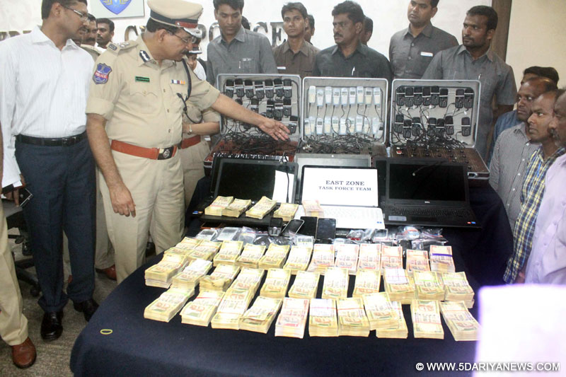 Hyderabad Police Commissioner M. Mahender Reddy presents before press cash and other things recovered after busting a cricket betting racket spread across four states in Hyderabad, on July 22, 2015