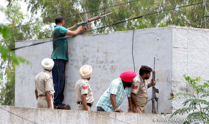 Dinanagar: Security personnel take positions outside Dinanagar police station, where the heavily-armed terrorists are holed up, on July 27, 2015.