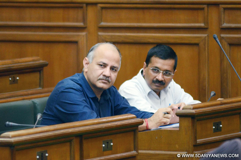 Delhi Chief Minister Arvind Kejriwal and Deputy Chief Minister Manish Sisodia interact at the Delhi Legislative Assembly on the Day 1 of the monsoon session of the house in New Delhi on Aug 3, 2015.