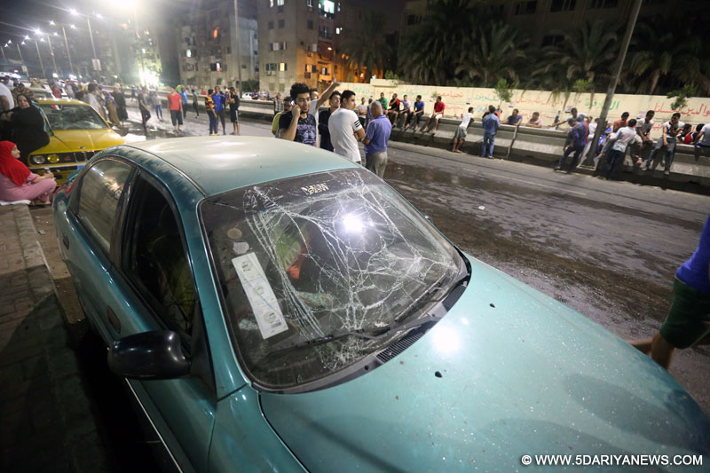 A car is damaged in a blast in the district of Shubra El-Kheima, Qaliubiya Governorate, Egypt, Aug. 20, 2015. At least 23 people, among them six policemen, got injured early Thursday in a blast that targeted a national security building in Qaliubiya Governorate, the Egyptian state TV reported.