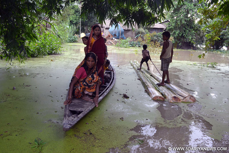 Morigaon: People ride a boat after water inundates Balimukh village in Morigaon district of north eastern Assam, on Aug 22, 2015. 