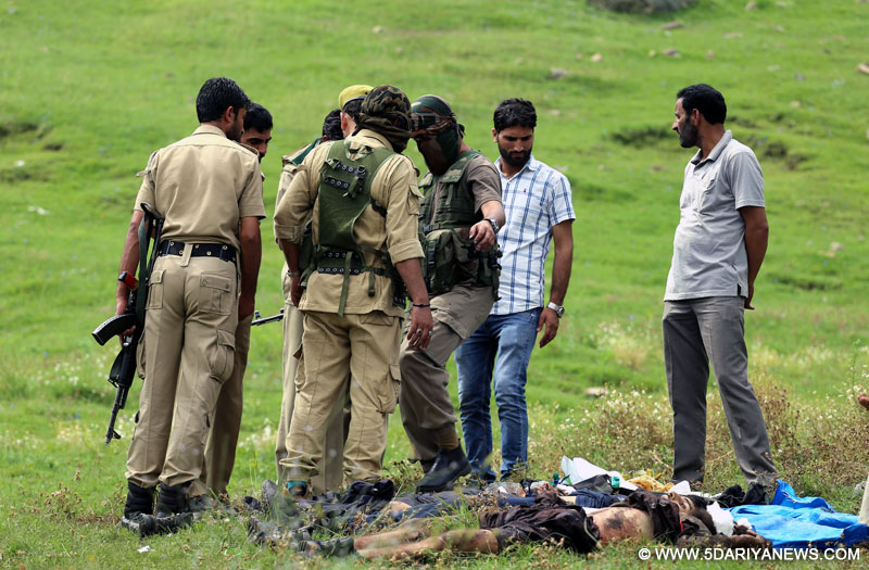 Handwara: Policemen stand near the bodies of three militants in Handwara of Jammu and Kashmir