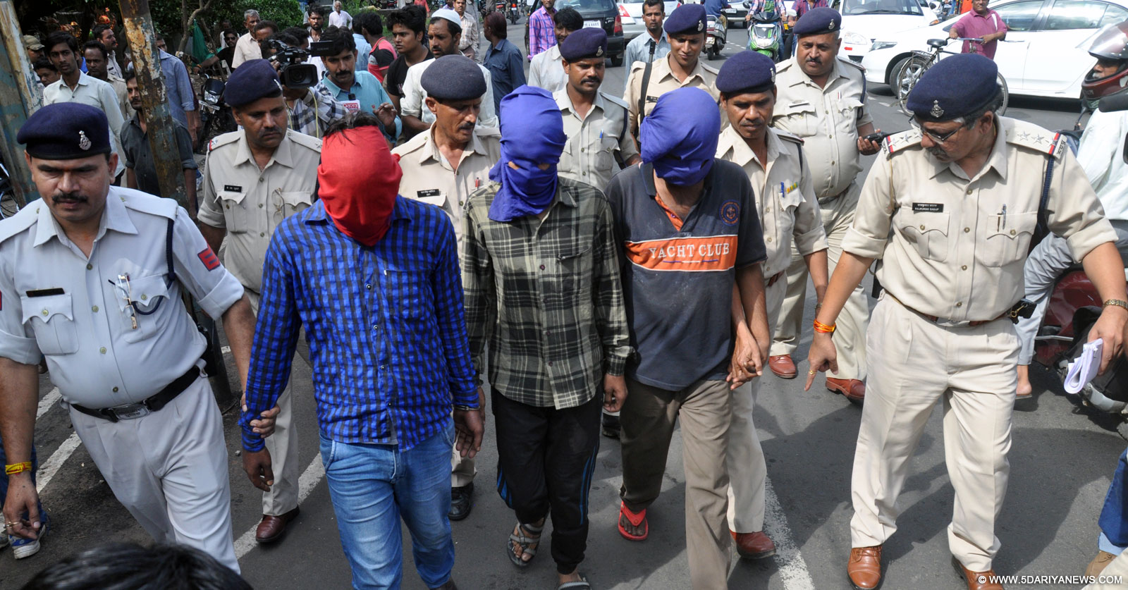 Police officials arrest the persons accused in gang rape of a woman who was allegedly raped in a moving local bus in Bhopal on Sep 18, 2015. 