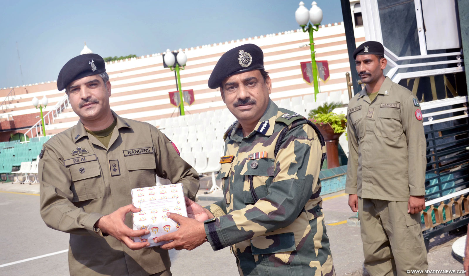 Attari: BSF DIG M F Farooqui presents sweets to Pakistan Rangers Commander Lt Col Bilal on Id-ul-Zuha at Attari-Wagha border, ear Amritsar on Sep 25, 2015. 