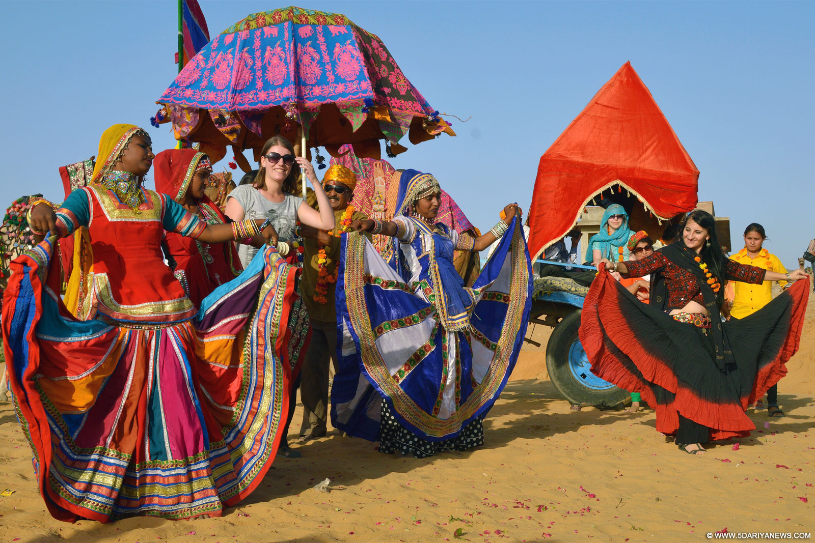 Pushkar: A foreign tourist dances with local artists on the eve of World Tourism Day in Pushkar of Rajashtan on Sep 26, 2015. 