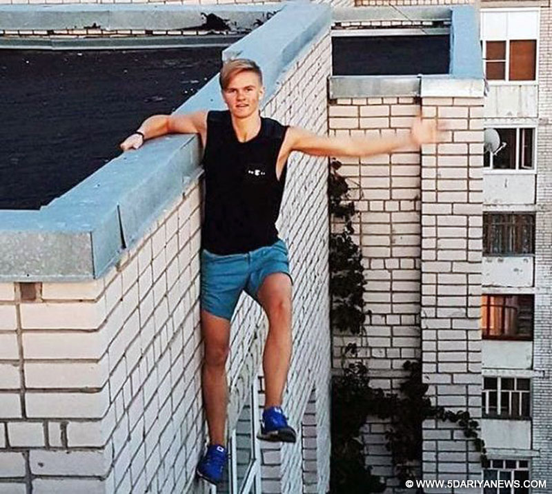 The 17-year-old student is seen hanging from a wall with one hand in a previous Instagram photo. 