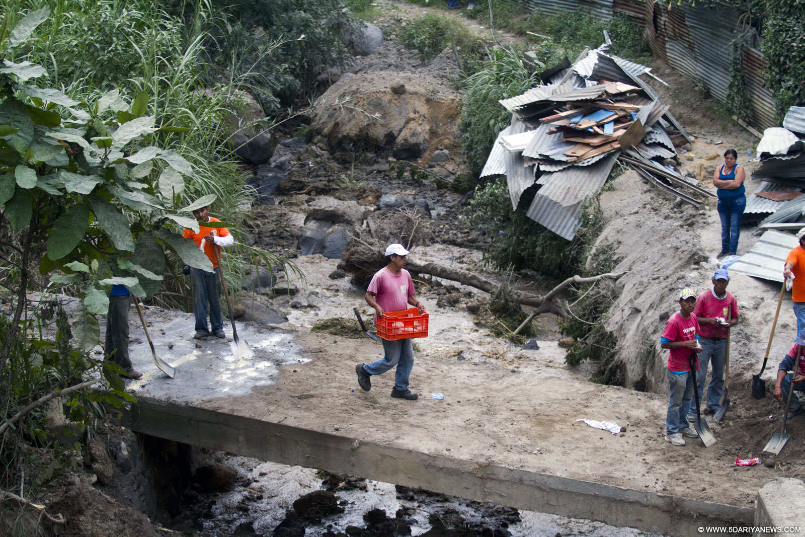 Residents collect their belongings after a landslide in Santa Catarina Pinula municipality, Guatemala department, Guatemala, on Oct. 2, 2015. At least 29 people were killed and 600 missing following a landslide that destroyed about 125 homes on the outskirts of the Guatemalan capital, officials said late Friday.
