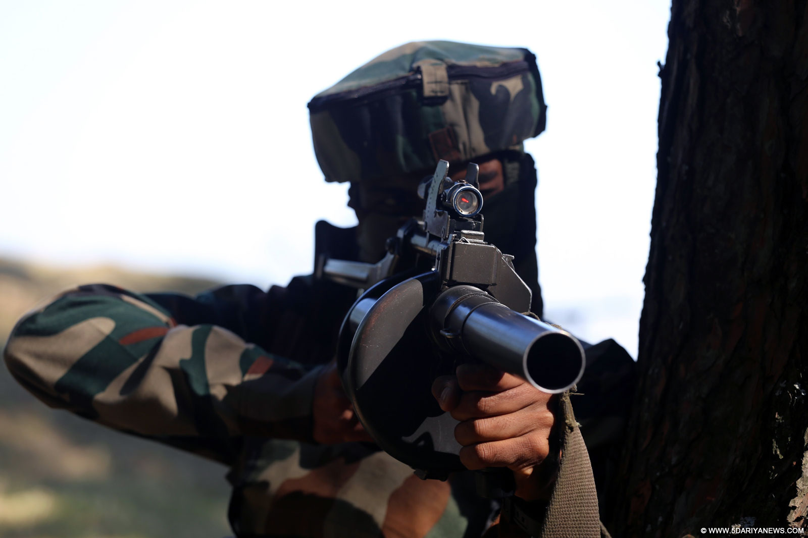 A soldier takes position during a gun battle with militants in Kursan area of Jammu and Kashmir