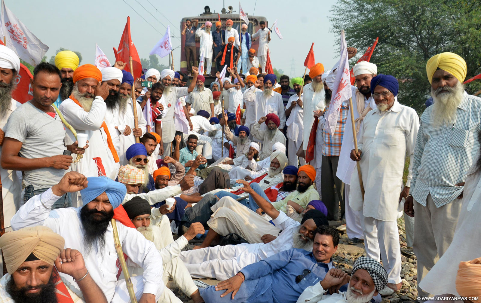 Farmers disrupt railway services in Khalchian near Amritsar to protest against low prices of Basmati rice on Oct 7, 2015. 