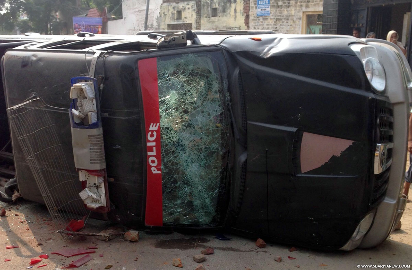 A police vehicle damaged after Sikhs protesting against desecration of their holy book clashed with police in Faridkot of Punjab on Oct 14, 2015.