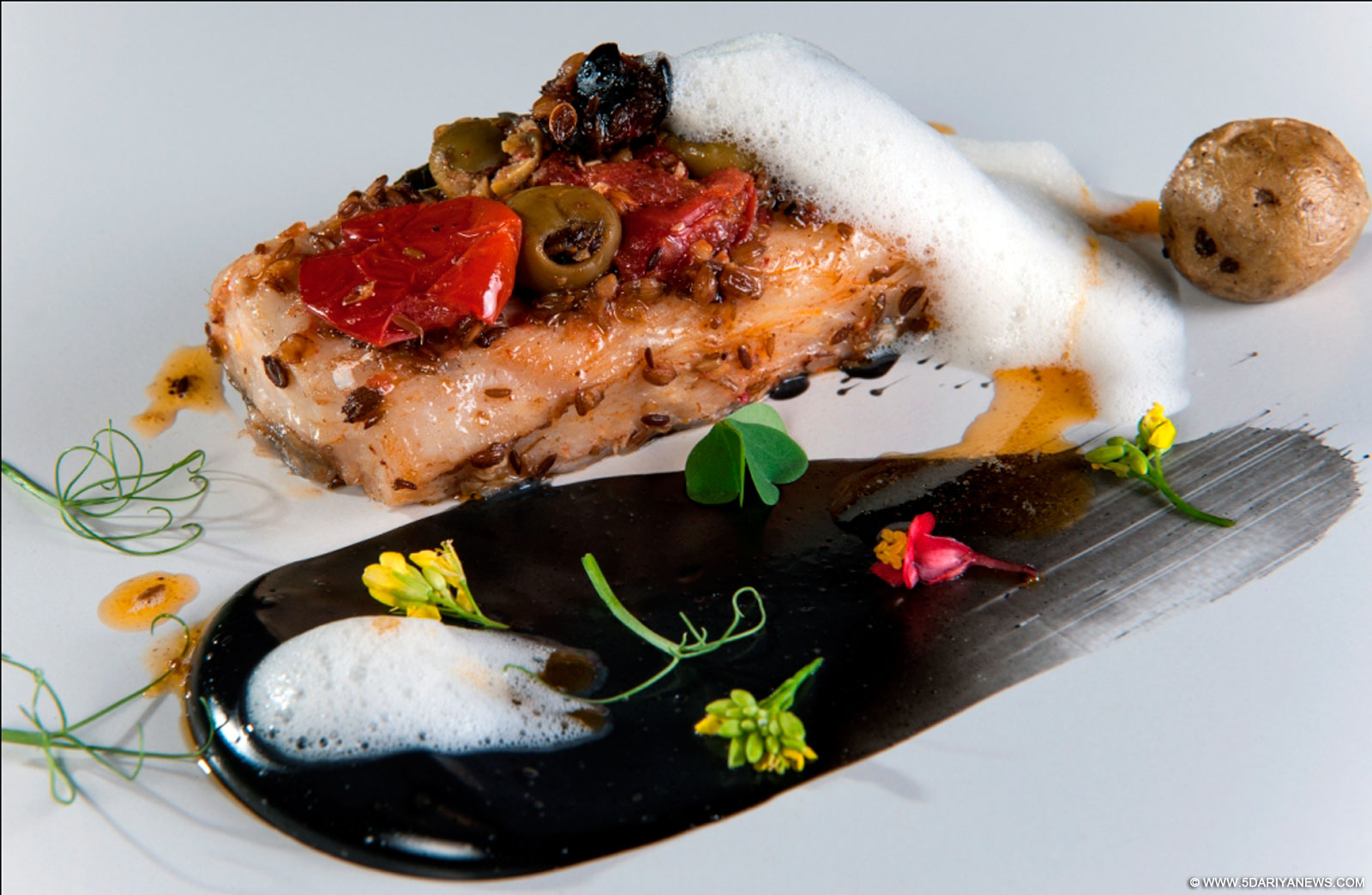 baked sea bass with olives, tomato and lime foam