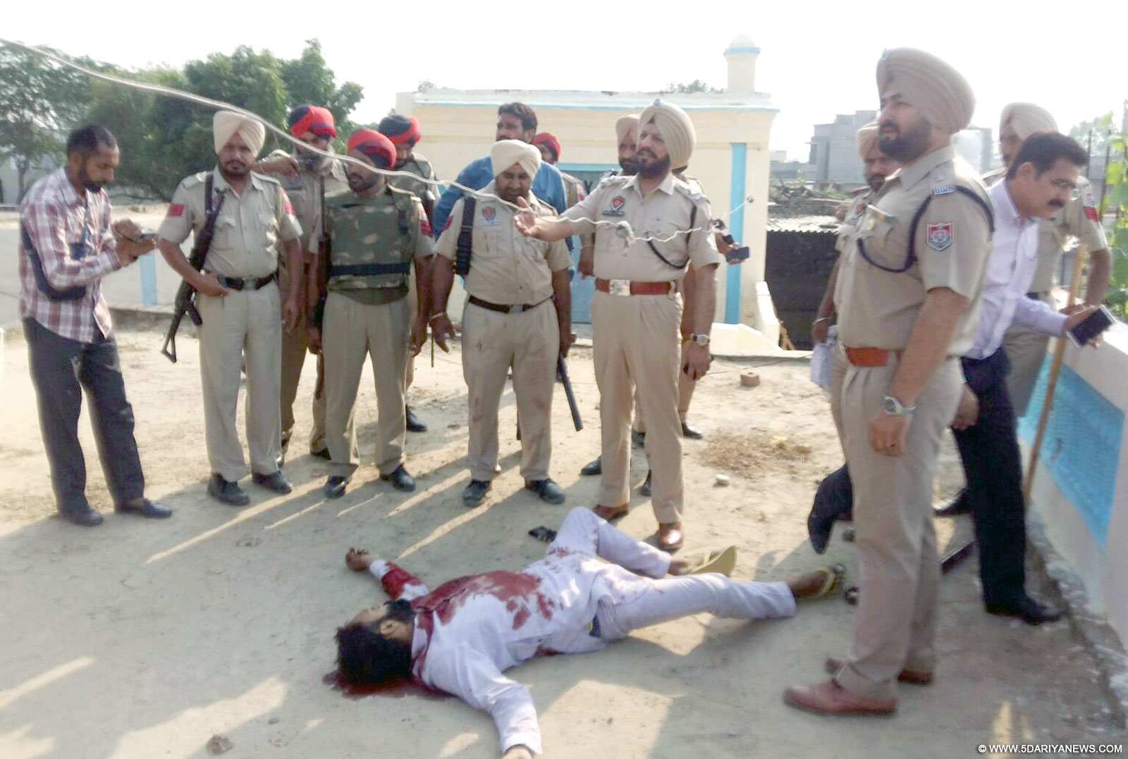 Punjab police officials at the spot where a soldier killed four of his neighbours in Sangrur, on Oct 20, 2015. 