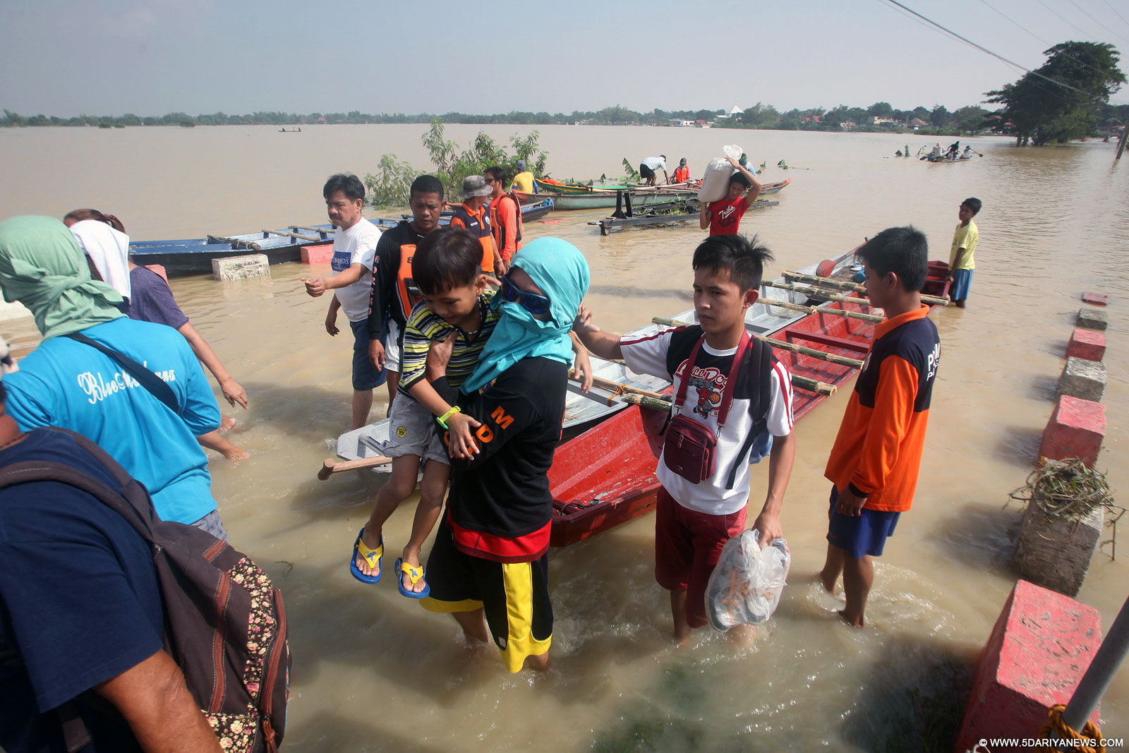 Local rescuers assist residents in Pampanga Province, the Philippines, Oct. 22, 2015. The Philippines