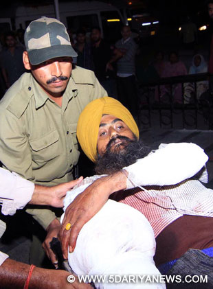 A civilian who was injured in Pakistan shelling in Mawa village of Samba district being shifted to GMC Hospital in Jammu, on Oct 24, 2015.