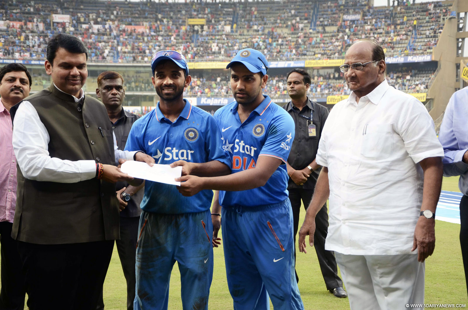 Indian cricketers Rohit Sharma and Ajinkya Rahane on behalf of Mumbai Cricket Association (MCA) hand over a cheque of Rs one crore towards Chief Minister
