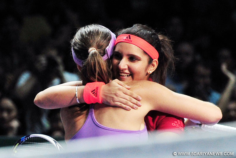 Martina Hingis (front) of Switzerland hugs Sania Mirza of India after the women