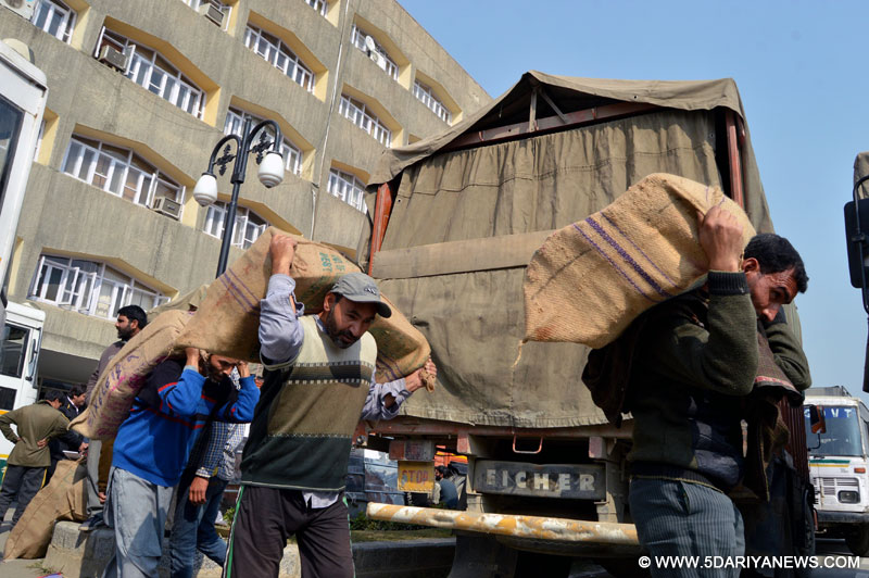Laborers shift officials documents to winter capital Jammu for the upcoming winter session at Civil Secretariat, in Srinagar 