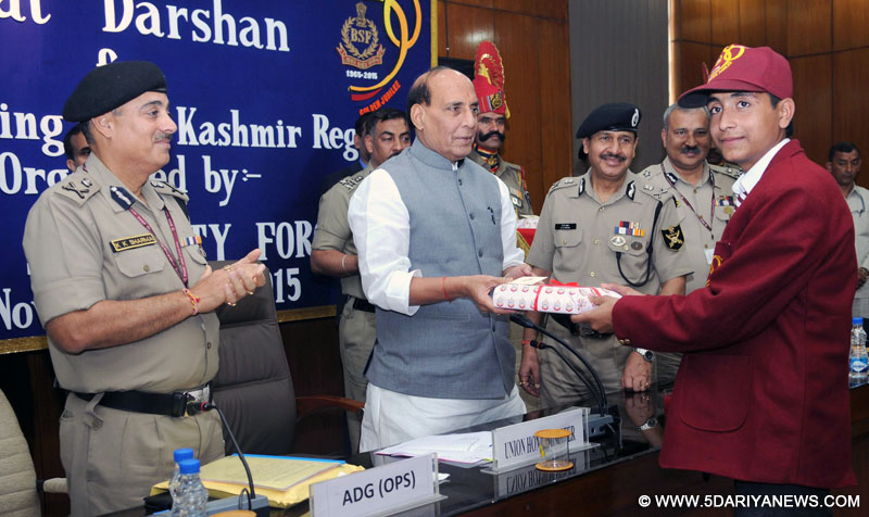 The Union Home Minister, Shri Rajnath Singh presenting gift to the school children from Kashmir region who are on a Bharat Darshan tour being conducted by the Border Security Force, in New Delhi on November 13, 2015. The Director General, BSF, Shri D.K. Pathak is also seen.