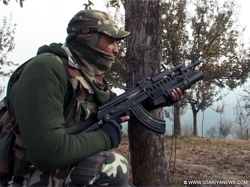 A soldier takes position during an encounter with militants in Handwara of Jammu and Kashmir