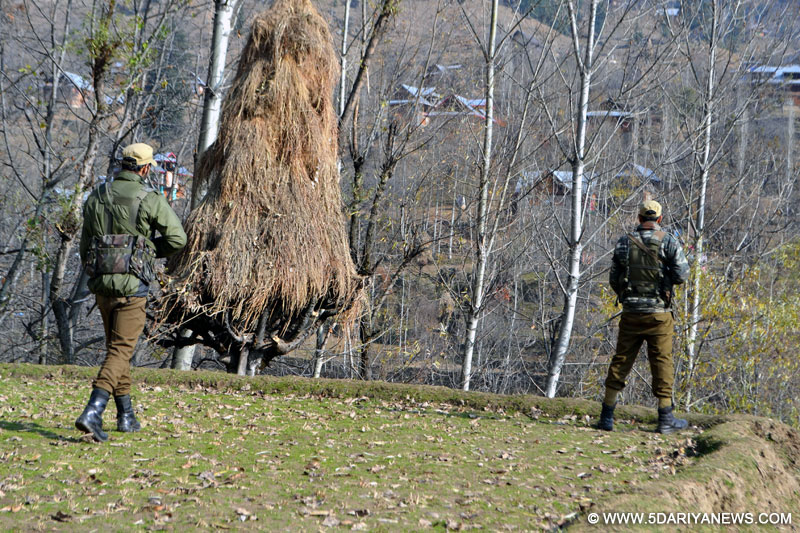Soldiers take position during an encounter with militants in Manigah of Jammu and Kashmir